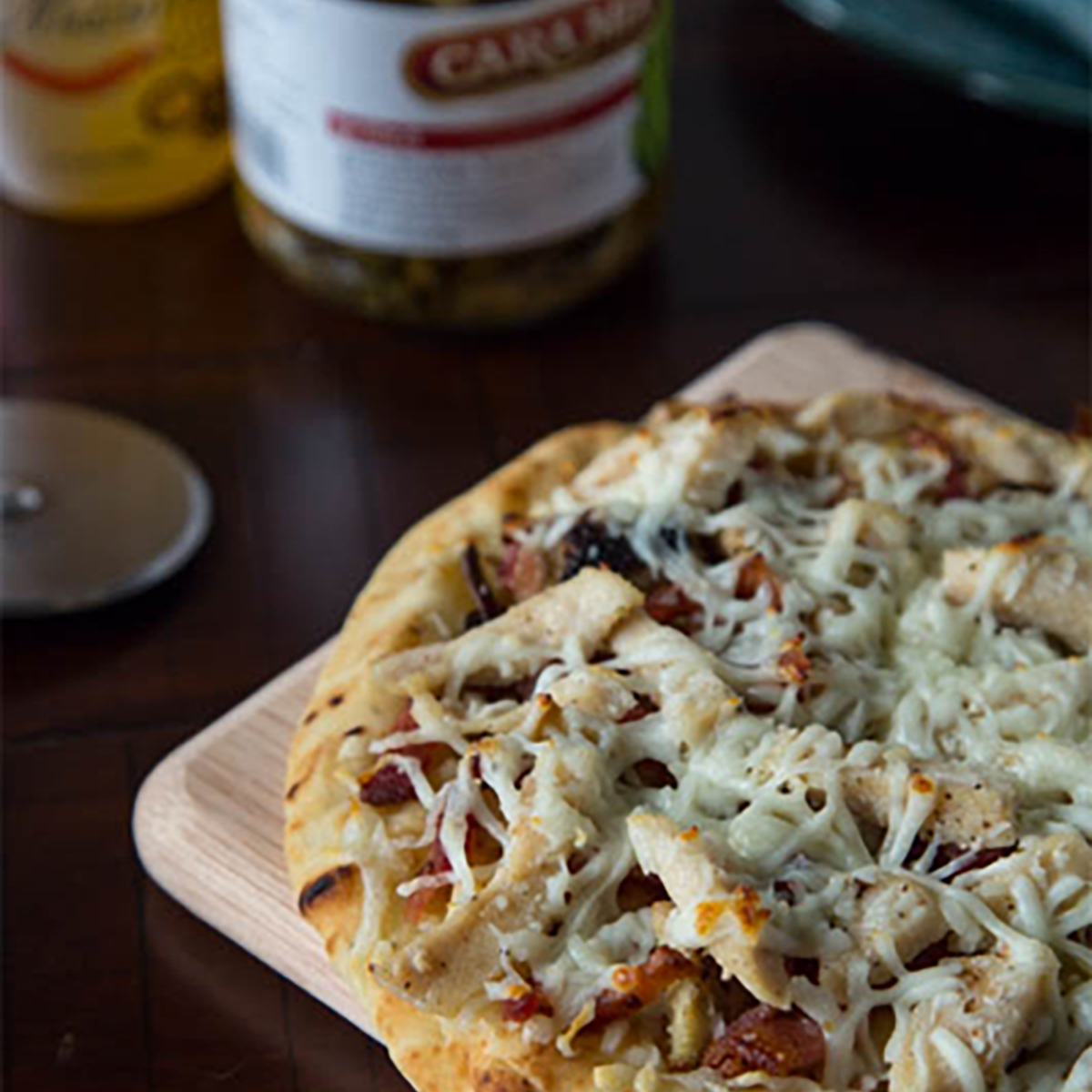 This quick and easy pizza contains naan bread topped with grilled artichokes, bacon, chicken, and cheese.  #STARFineFoods