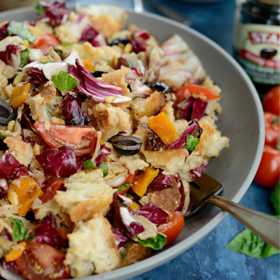 This panzanella is made with an assortment of grilled veggies tossed with sweet, ripe campari tomatoes, STAR Pitted Ripe Olives Without Liquid and hand-torn, toasted ciabatta pieces with a killer tomato vinaigrette drizzled over top. #STARFineFoods