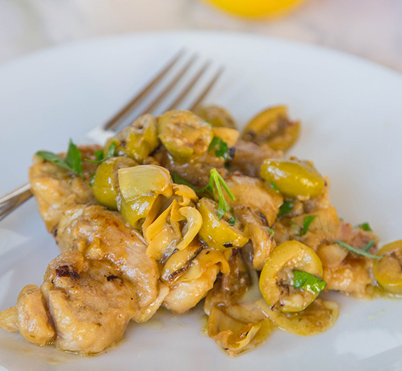 A complete chicken dinner in one pan.  Chicken thighs in a lemony sauce with artichokes and green olives. #STARFineFoods