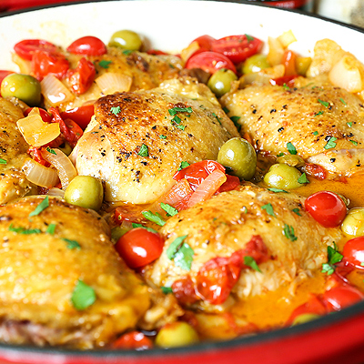 Perfectly cooked tender and juicy chicken thighs with golden brown crispy skin, finished in a incredible tomato-wine sauce with STAR Olives. This is a simple recipe that's sure to be on your menu again and again. #STARFineFoods