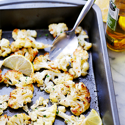 This recipe creates tender roasted cauliflower tossed in olive oil, seasoned with a delicious lemon-paprika mixture, and roasted to a perfect golden brown. #STARFineFoods